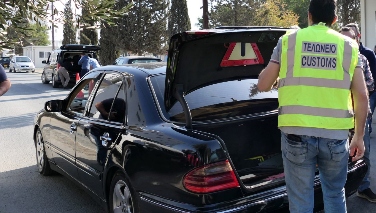 PHOTO: A mother and daughter loaded down with cartons of cigarettes were "caught" at the roadblock, handcuffed and accompanied by Turkish Cypriots