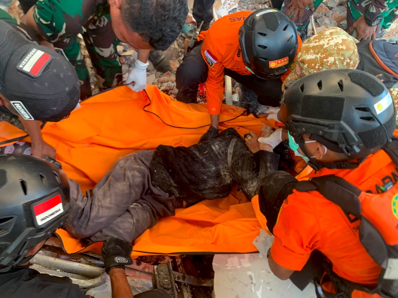 As rescue workers search through the rubble following the 7.7-magnitude earthquake, another powerful quake struck Indonesia